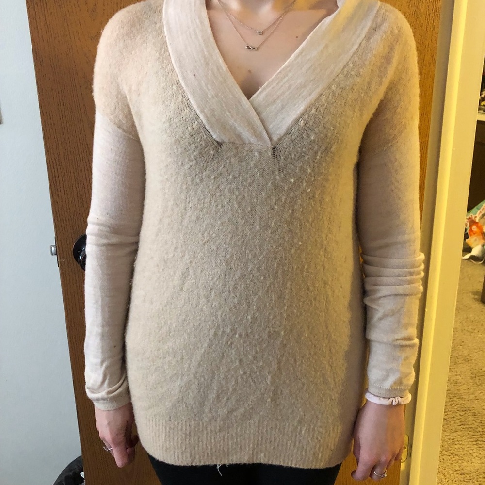 Slightly worn pink sweater.